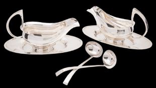 A pair of Elizabeth II Irish silver sauce boats, stands and ladles, maker Brian Clarke, Dublin,