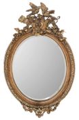 A Victorian giltwood, gesso and grained oval mirror:,