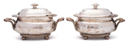 A pair of Sheffield plate tureens and covers: of oval outline with domed lift-off lids,