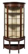 A carved mahogany demi-lune upright display cabinet:,