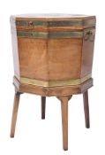 A George III mahogany and brass bound octagonal wine cooler:,