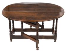 A George I oak gateleg table:, on an oval hinged top, on turned baluster legs,