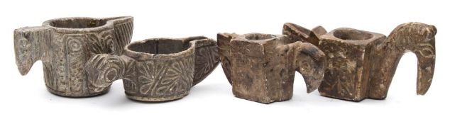 A group of four Islamic carved alabaster oil lamps: in the form of stylised birds: of traditional