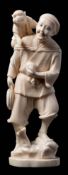 A Japanese carved ivory okimono: in the form of a standing smiling man,