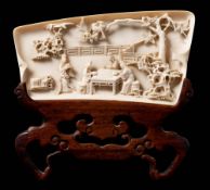 A Chinese carved ivory calligrapher's wrist rest: of rectangular outline,