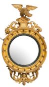 A Regency carved giltwood and gesso circular convex mirror:,