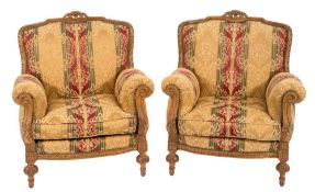 A Continental carved beech three piece suite:, comprising a three seat settee and pair of armchairs,