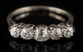 A graduated diamond five-stone ring: the round old brilliant-cut diamonds estimated to weigh a