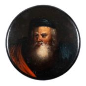A 19th century papier mache snuff box: the circular lid decorated with a portrait of a bearded