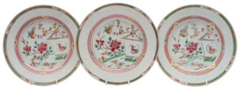 A set of three Chinese famille rose plates: each enamelled with a garden terrace scene with birds,
