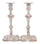 A matched pair of silver cast candlesticks, maker William Cafe, London, 1759 and 1765.