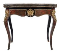 A 19th Century French ebonised and gilt metal mounted card table:, of serpentine outline,