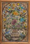 A panel of six Qajar pottery tiles: decorated in bright colours with a vase of flowers and foliage,