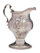 A George III silver pedestal cream jug, maker's mark worn, London, 1768: monogrammed,