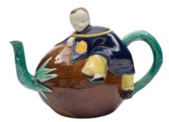 A Joseph Holdcroft majolica teapot and cover: modelled as a Chinese boy clambering onto a coconut