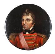 A 19th century papier mache snuff box: the circular lid decorated with a portrait of the Duke of