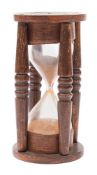 A 19th century sand-filled hourglass: the frame with four turned spindles, 16.5 cm.