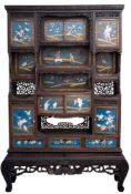 A Japanese carved wood and inlaid lacquer display cabinet: in the form of six cupboards and three