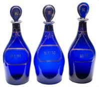 A group of seven Bristol blue glass decanters and stoppers: each of mallet shaped form with lozenge