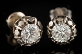 A pair of diamond single-stone ear studs: each with a circular,