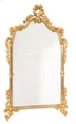 A pair of carved giltwood wall mirrors:, of shaped arched outline with flowerhead,