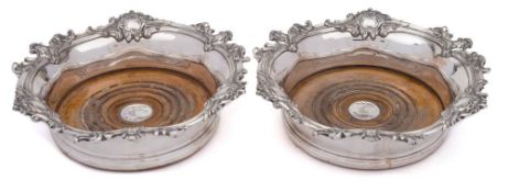 A pair of Victorian silver plated coasters: of circular outline with scroll and foliate decorated