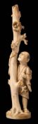 A Japanese carved ivory okimono: depicting a peasant looking at a birds nest on a tree stump,