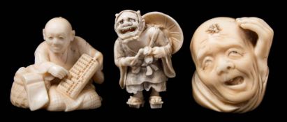 A group of two Japanese carved ivory netsukes together with an okimono: the first netsuke in the