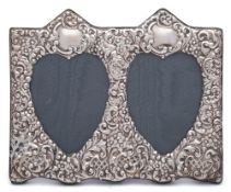 An Elizabeth II silver embossed double heart easel photograph frame, maker Paul Vernon Fitchie,