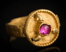 A Saxon migration period gold ring: inset with a later single cabochon ruby,