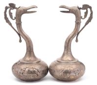 A pair of Indo-Persian silver ewers: each of squat globular form with slender curved neck and spout