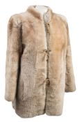 A lady's overcoat by Yves Saint Laurant:, with black fur collar and cuffs,