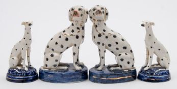 Two pairs of Staffordshire pottery Dalmatians: both in seated posture,