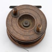 A mahogany and brass 3 inch half starback reel:, unsigned, with double horn handles.