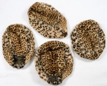 A set of four late Victorian/early Edwardian leopard skin foot warmers, circa 1900,