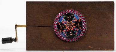 A 19th century mechanical chromotrope magic lantern slide:, with double frame image, unsigned,