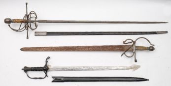 A reproduction swept-hilt rapier and two other reproduction swords.