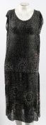An early 20th century black cotton and beadwork dress:, circa 1920s,