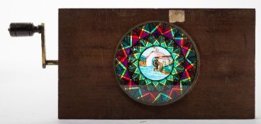 A 19th century mechanical hand painted three frame chromotrope magic lantern slide:,