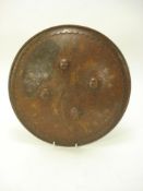 A 19th century gilt inlaid steel dhal:, the domed body with four flower head bosses,