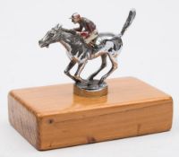 A chrome plated Racing horse car mascot: with jockey up, painted in red and white silks,