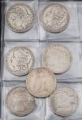 A collection of seven American dollar coins: 1884, 1885, 1889, 1890, 1922, 1921, 1922. (7).