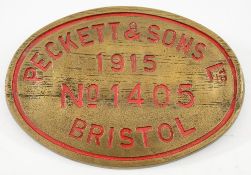 An oval brass worksplate Pecket & Son Ltd, Bristol No 1405, 1915:, red filled text, 31cm long.