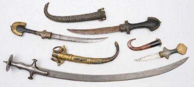 Two late 19th/early 20th century jambiyas:, one with brass decoration,