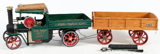 A Mamod SW1 live steam wagon in 'Eddie Stobart 'livery:, green cab and chassis, red spoked wheels,
