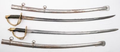 A pair of reproduction British pattern cavalry swords:, both with curved blades,