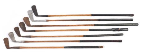 A group of seven early 20th century hickory shaft golf clubs:,