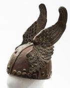 A reproduction copper and brass winged Vizigoth style conical helmet,: 31cm high.