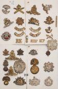 A group of WWI and later cap badges and helmet plates:, including Argyll & Sutherland,