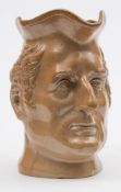 A Stephen Green salt glazed stoneware 'Wellington' character jug: with scroll handle,
